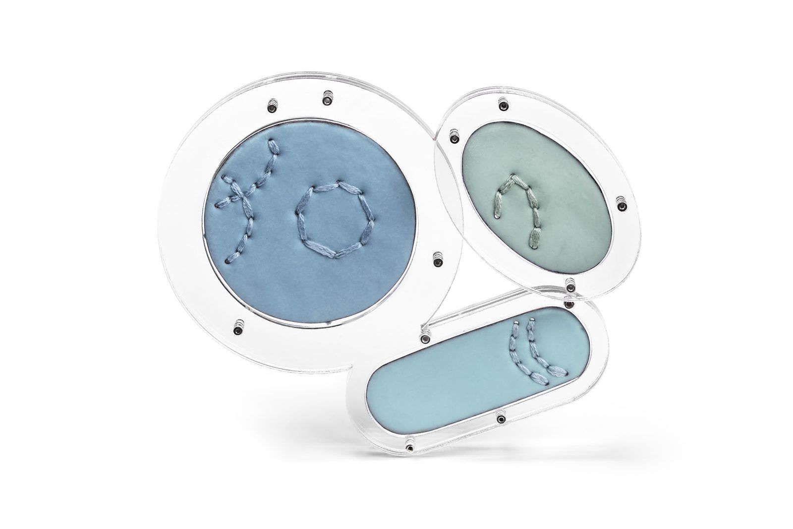 Three blue enamel brooches with stitched dots