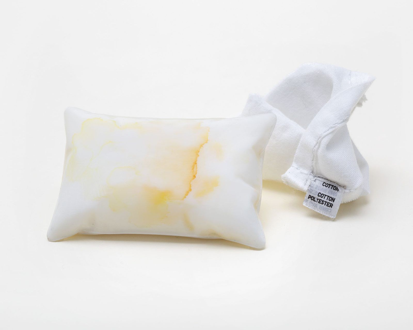 Two small linen pillow pendants with yellow staining