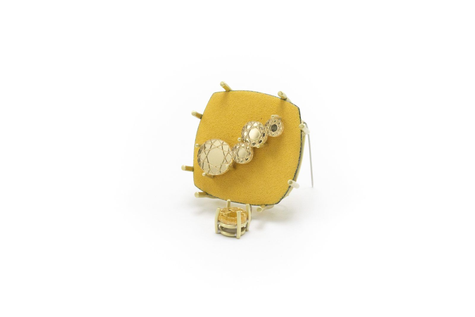 Yellow brooch with a trail of round gold discs and a small hanging stone