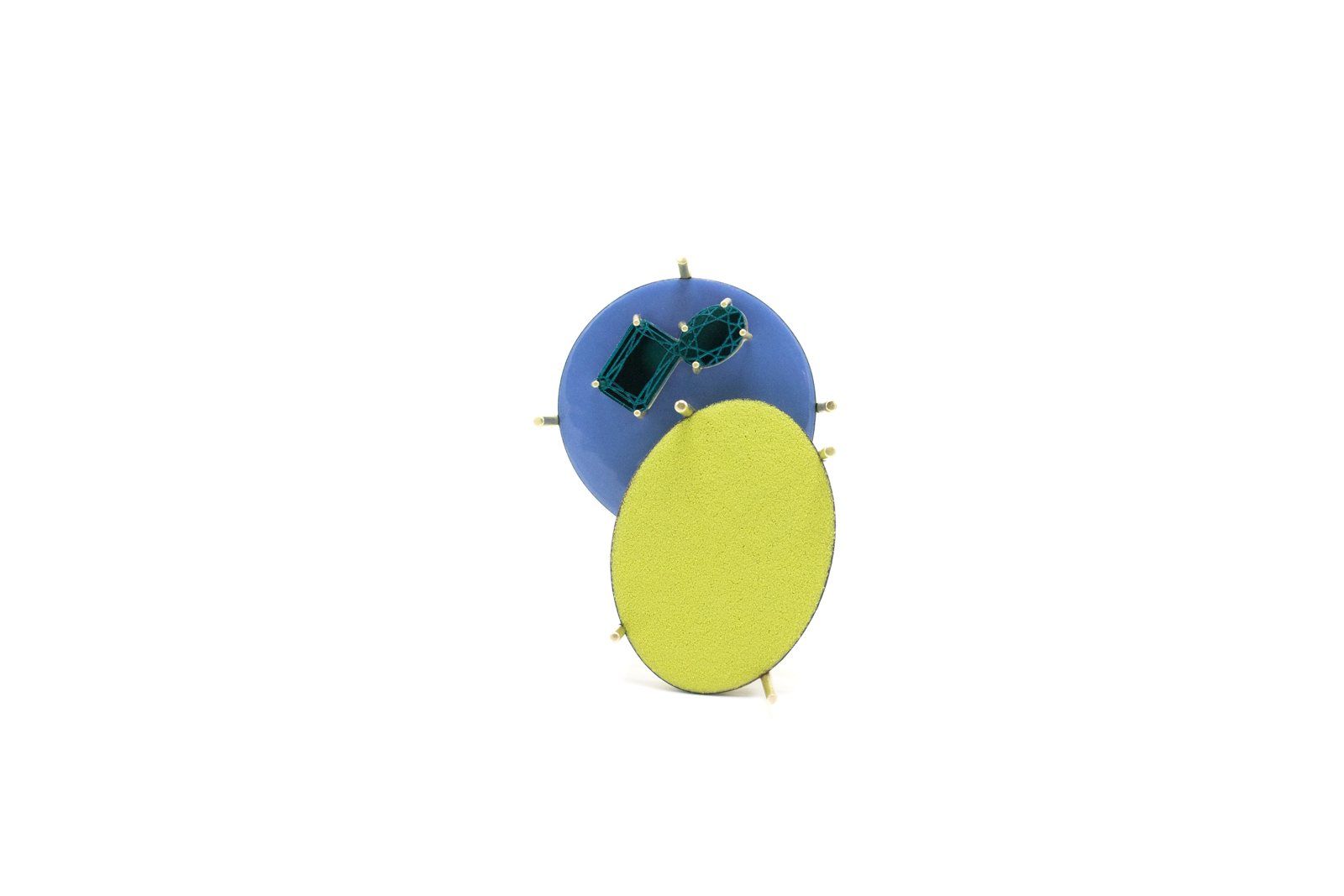 Enamel brooch: a blue circle with green stones overlapping a large yellow oval