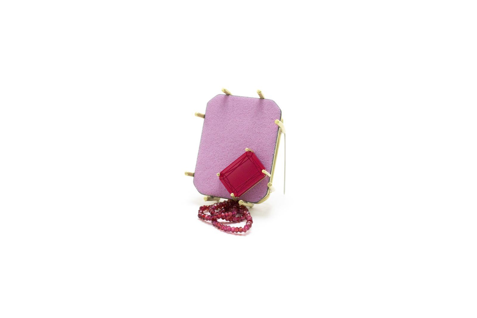 Lilac brooch with a red rectangular stone and a strand of red beads