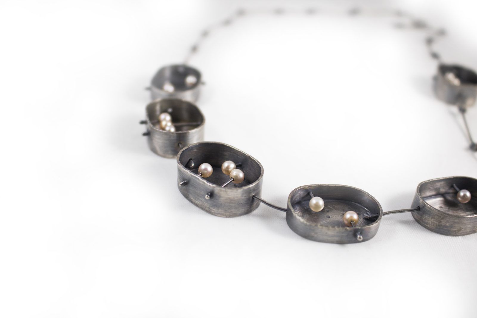 Dark oxidized necklace with small pearl details