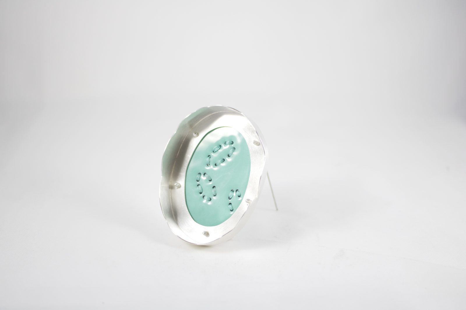 Mint enamel brooch with stitched pattern